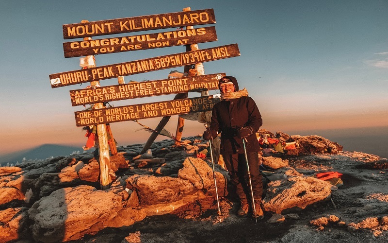 Climber summits in 10 days Kilimanjaro climbing Northern Circuit route